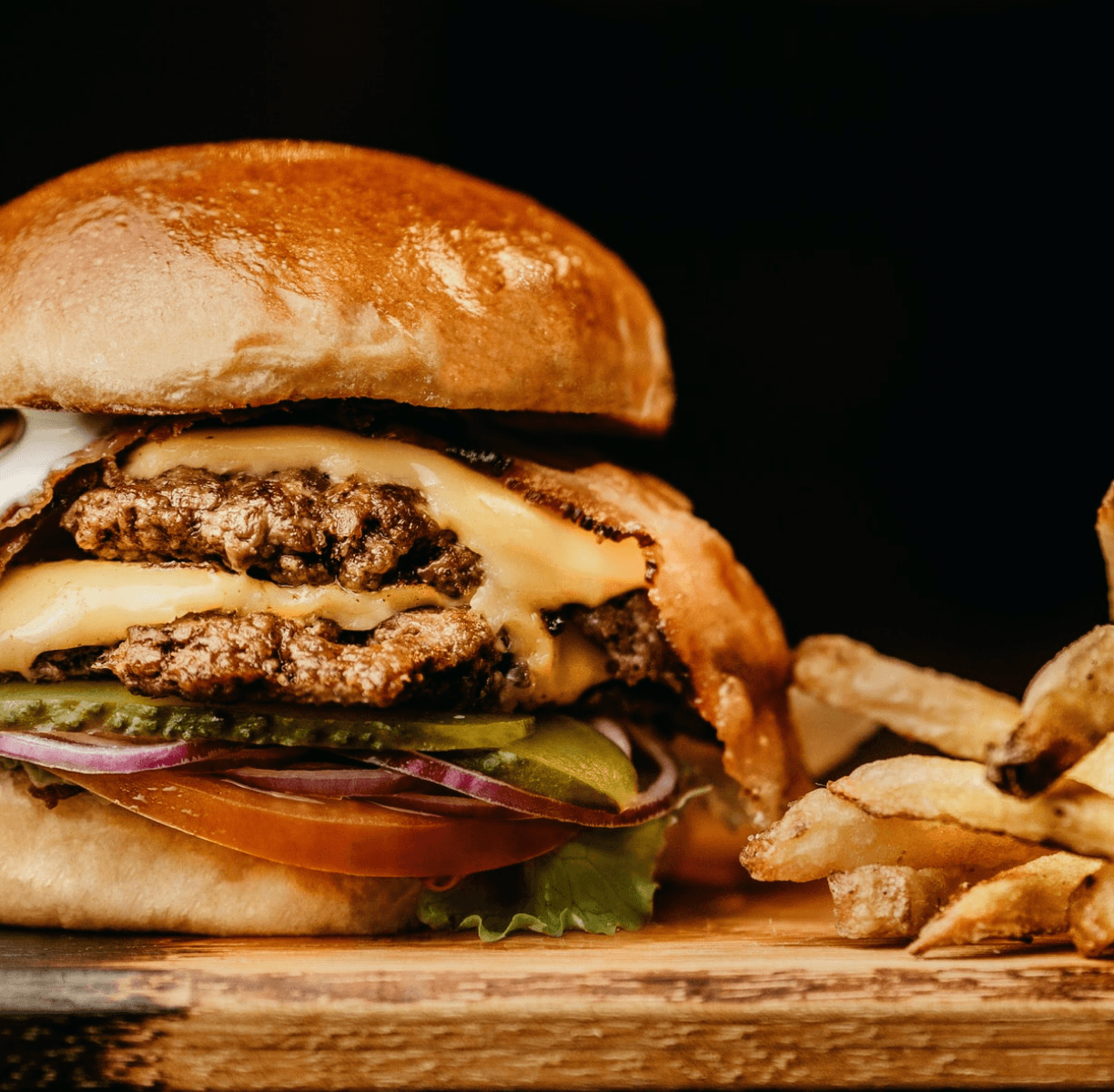 Our delicious beef burger with pickles, onions, tomato, cheese, and bacon